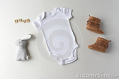 White Baby Bodysuit, Shoes, Toy & Letters - Baby One Piece Mockup Stock Photo