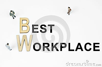 On a white background, figures of businessmen, wooden letters and the inscription - BEST WORKPLACE Stock Photo
