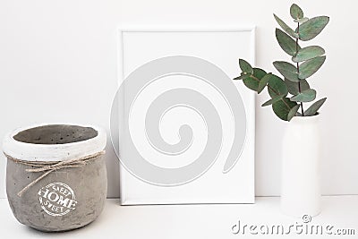 White background frame mockup, green eucalyptus in ceramic vase, cement pot, styled image Stock Photo