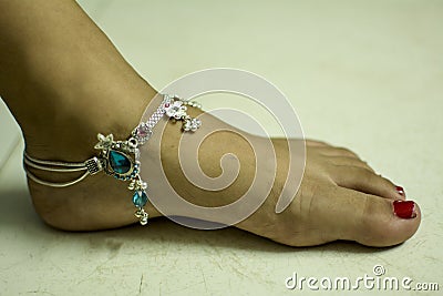 Indian woman feet wearing ethnic jewellery on white background Stock Photo