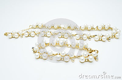 On a white background lies a pearl necklace on the neck and bracelet Stock Photo