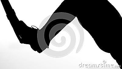on a white background, a shadow, a black outline of a female figure doing exercises for the press Stock Photo