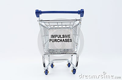 On a white background is a shopping cart with a sign that says - impulsive purchases Stock Photo