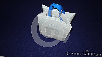 White bag and blue color handle, non woven bag on Dark Blue Background Stock Photo