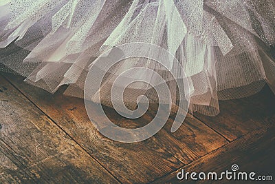 White ballet tutu on wooden floor. Retro filtered Stock Photo