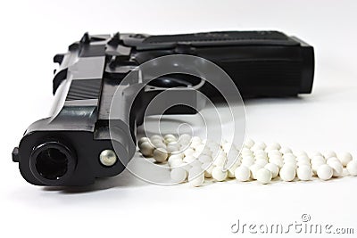 White balls with an black gun Stock Photo