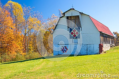 Red roofed white barn with quilts in West Virginia Stock Photo