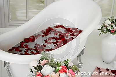 White bath with rose petals. Taking a bath with roses. Stock Photo