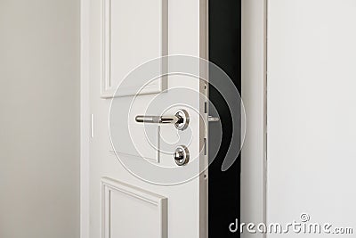 White bathroom door slightly open or left ajar Stock Photo