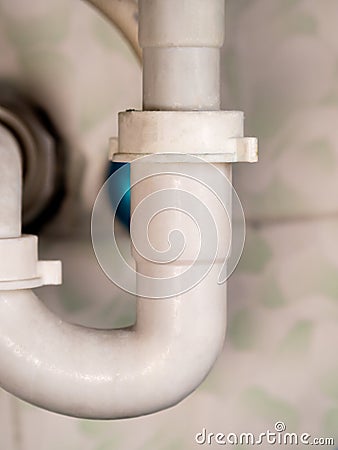 white bathroom drain pipe pipes and ceramic wall Stock Photo