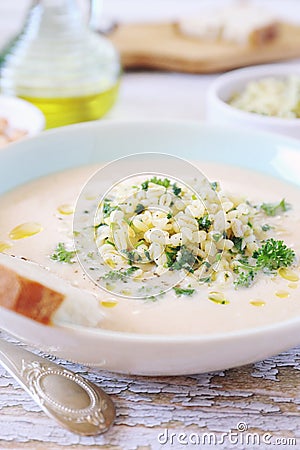 White bean cream soup with fried pearl barley and parsley, bread and olive oil Stock Photo