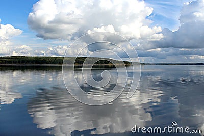 White clouds on blue sky with reflection in lake during the day in the natural environtent. Stock Photo