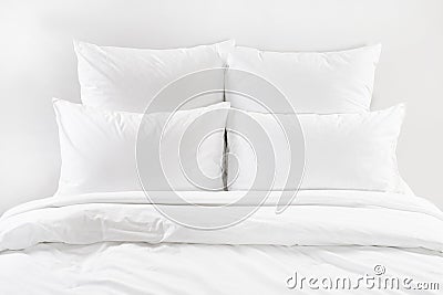 White bed , four white pillows and duvet on a bed Stock Photo