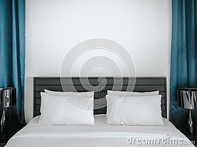 White bed with pillows in bedroom Stock Photo