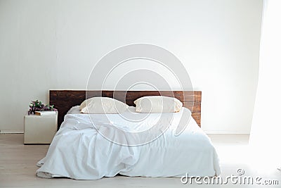 White bedroom bright interiors with bed and flowers Stock Photo