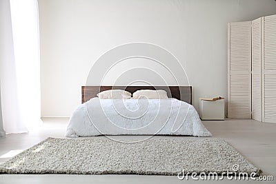 White bedroom bright interiors with bed Stock Photo