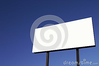 White Billboard with pure blue sky - sun on lower right Stock Photo