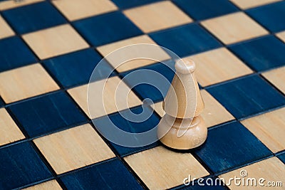 White bishop on wooden chessboard Stock Photo