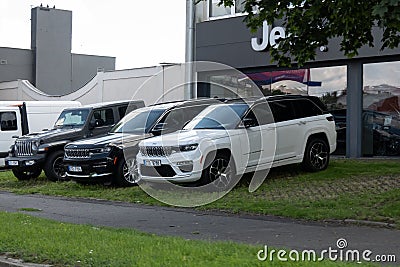 White and black Jeep Grand Cherokee WL American SUV at the dealership Editorial Stock Photo