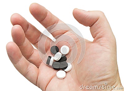 White and black pills in your palm Stock Photo