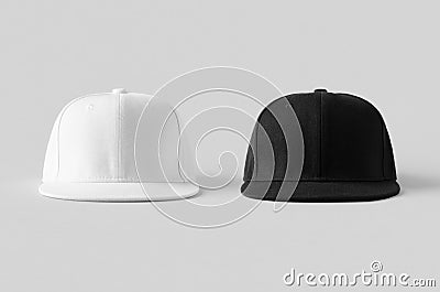 White and black snapback caps mockup on a grey background, front view Stock Photo