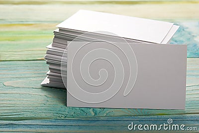 White blank business visit card, gift, ticket, pass, present close up on blurred blue background. Copy space Stock Photo