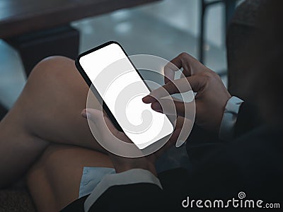 White blank mobile smart phone screen holding by businessperson who using finger touch and pinch for zoom in or zoom out. Stock Photo