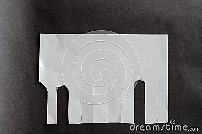 White blank sheet of paper with tear-off tabs on gray background Stock Photo