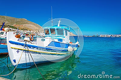 White-blue boat with Greek colors in bay, Greece Stock Photo