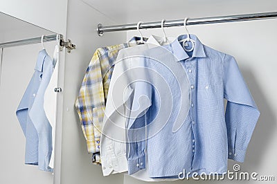 White, blue and checkered clean ironed men's shirts Stock Photo