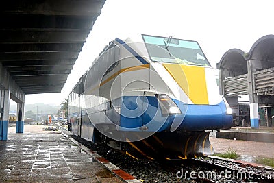 A white and blue diesel train car stands at the station Stock Photo