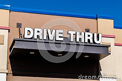 White and Blue Drive Thru sign set against a blue sky II Stock Photo