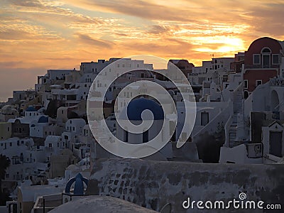 White and blue Greek Island Style architecture against golden evening sky at Oia village, Santorini Island Stock Photo