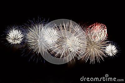 White, blue and red fireworks display on dark sky background Stock Photo