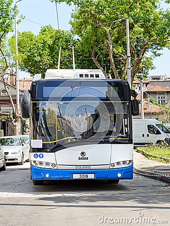 White blue Skoda trolleybus is based on Solaris vehicle on a city street on a sunny summer day. Modern city public electric Editorial Stock Photo