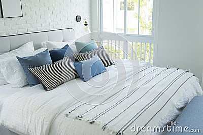 White and blue spacious bedroom with a large bed, in the Scandinavian style. Stock Photo