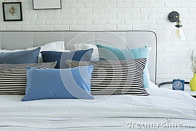 White and blue spacious bedroom with a large bed, in the Scandinavian style. Stock Photo