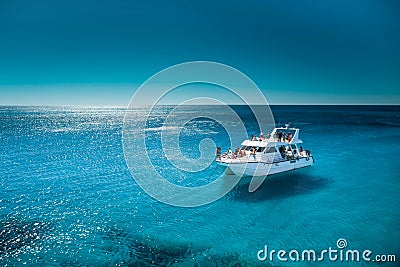 White boat in the sea with clean transparant blue water Stock Photo