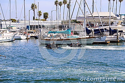 White boats and yachts at the docks in the harbor with deep blue ocean water and blue sky at Burton Chace Park Editorial Stock Photo