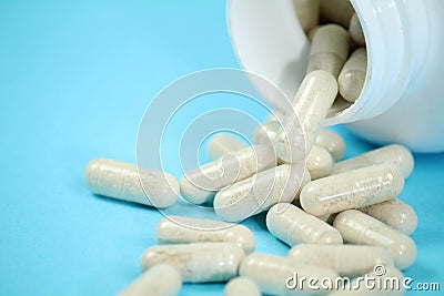 Bottle of capsules on blue background Stock Photo