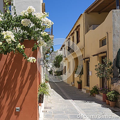 The white bougainvillea, the colorful houses, the lanterns and the many planters characterize the cozy alleys in the old town of R Stock Photo