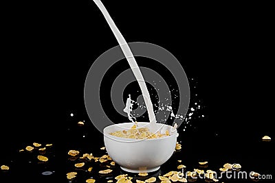 Bowl with cornflakes with milk stream Stock Photo