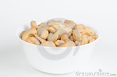 White bowl filled with roasted cashew nuts Stock Photo