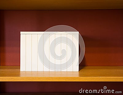 White box on wooden shelve Stock Photo