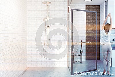 White brick bathroom with glass door, woman Stock Photo