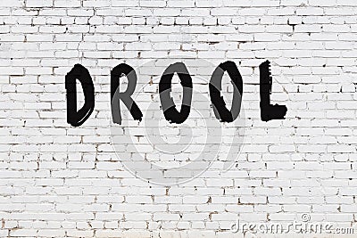 White wall with black paint inscription drool on it Stock Photo