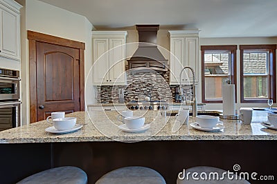 White and brown cabinets luxury huge kitchen interior with amazing details and top noch appliances Stock Photo