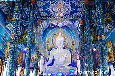 White buddha statue in Wat Rong Sua Ten temple with blue sky background, Chiang Rai Province, Thailand Stock Photo