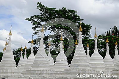 White buddhist pagodas with trees background, Myanmar Stock Photo