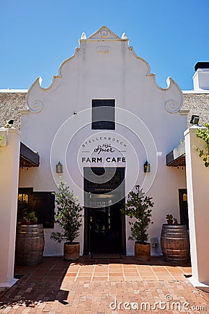 White building with an inviting entranceway featuring a front door. Farm cafe in Stellenbosch Editorial Stock Photo